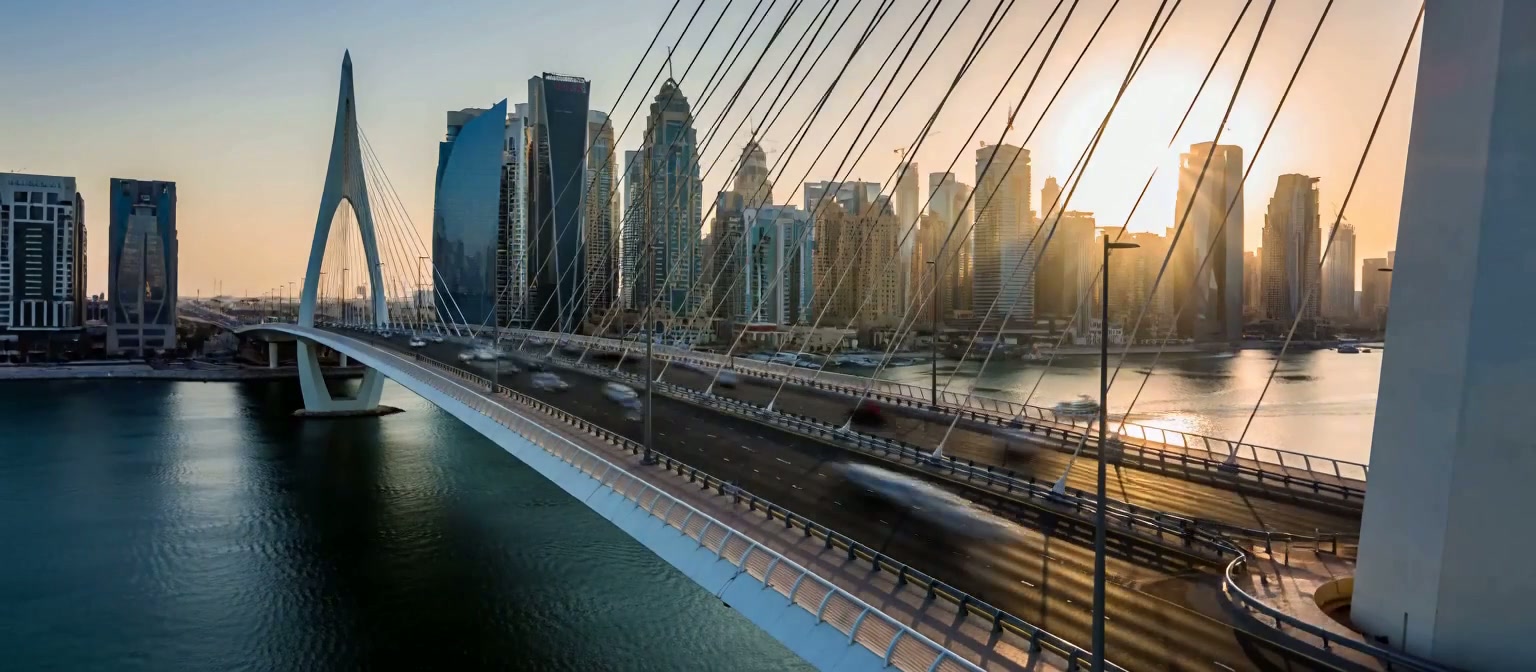 Modern bridge and Dubai skyline at sunset